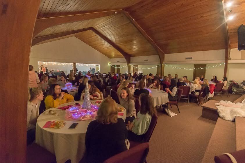 A full room of women at the tables